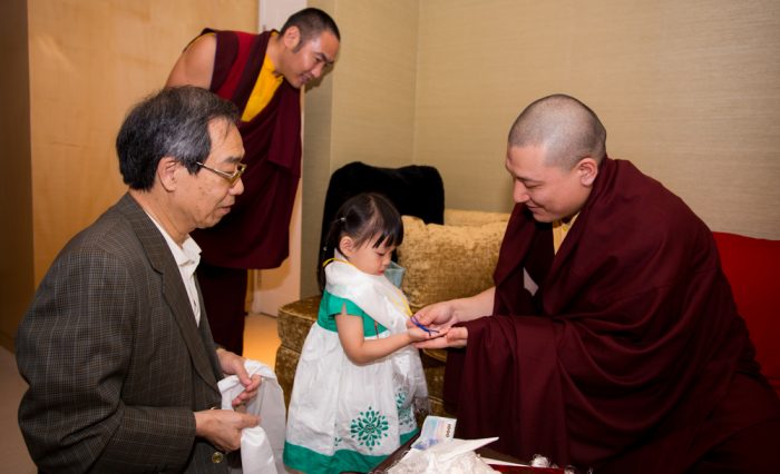 Thaye Dorje, His Holiness the 17th Gyalwa Karmapa, blessing a girl