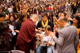 A student receives a blessing from Thaye Dorje, His Holiness the 17th Gyalwa Karmapa, at the Chenresig empowerment in Hong Kong