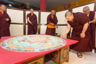 Thaye Dorje, His Holiness the 17th Gyalwa Karmapa, puts the finishing touches on the sand mandala of Chakrasamvara