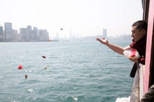 Thaye Dorje, His Holiness the 17th Gyalwa Karmapa, offers flowers in a traditional fish release ceremony in Hong Kong