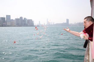 Thaye Dorje, His Holiness the 17th Gyalwa Karmapa, offers flowers in a traditional fish release ceremony in Hong Kong