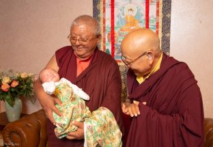 Jigme Rinpoche, Karmapa's General Secretary and Solponla Tsultrim Namgyal, Karmapa's Senior Attendant, smile at Thugsey (Karmapa's son)