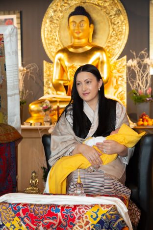 Sangyumla Rinchen Yangzom cradles Thugsey (her son) during a special reception at Dhagpo Kagyu Ling