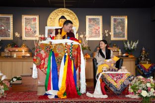 Thaye Dorje, His Holiness the 17th Gyalwa Karmapa, shares a smile with Sangyumla Rinchen Yangzom and Thugsey (their son) during a special reception at Dhagpo Kagyu Ling