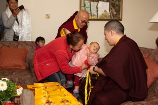 A young girl gazes up at Karmapa