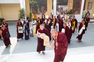 Monks greet Karmapa and baby Thugsey