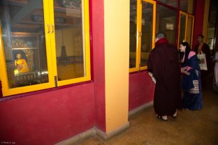 Karmapa and Sangyumla Rinchen Yangzom look into the shrine hall at KIBI