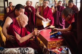 His Eminence Luding Khenchen Rinpoche, the 75th head of the Ngor tradition of the Sakya school of Tibetan Buddhism, presides over the hair-cutting ceremony of Thugsey, in the presence of Karmapa, Sangyumla and many monks from various Karma Kagyu monasteries