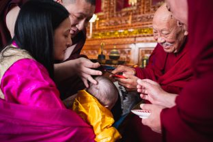 The moment when His Eminence Luding Khenchen Rinpoche, the 75th head of the Ngor tradition of the Sakya school of Tibetan Buddhism, cuts the hair of Thugsey, symbolizing his taking refuge in the Three Jewels: the Buddha, the dharma and the sangha