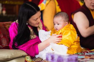 A tender moment as Sangyumla holds little Thugsey during the hair-cutting ceremony