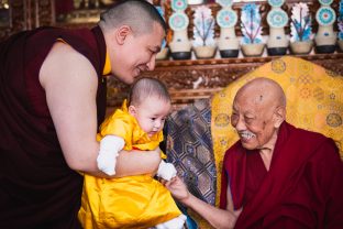 His Eminence Luding Khenchen Rinpoche, the 75th head of the Ngor tradition of the Sakya school of Tibetan Buddhism, smiles warmly at little Thugsey, Karmapa's son