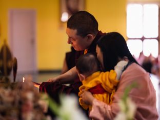 A light of hope: Karmapa, Sangyumla and Thugsey light the butter lamp at the altar at KIBI