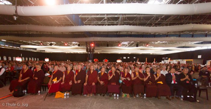 The monks among a sea of people at the Alpexpo convention centre in Grenoble