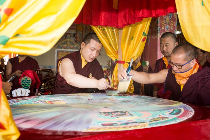 Thaye Dorje, His Holiness the 17th Gyalwa Karmapa, dissolving the sand mandala on the final day of the Gyalwa Gyamtso puja. Photo / Magda Jungoska