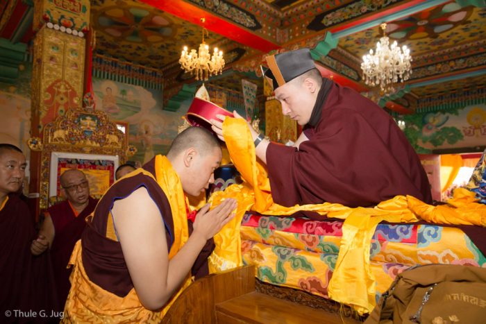 Thaye Dorje, His Holiness the 17th Gyalwa Karmapa, presents the red hat of activity to HE Jamgon Kongtrul Rinpoche at the Kagyu Monlam 2016