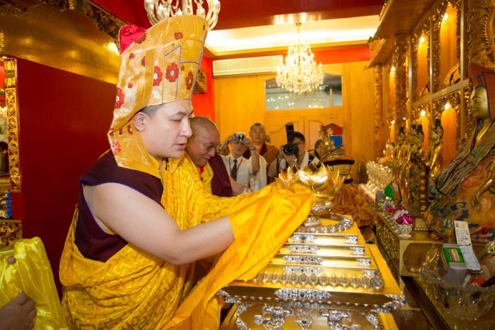 Thaye Dorje, His Holiness the 17th Gyalwa Karmapa, puts the relics of Shamar Rinpoche inside the stupa. Photo / Thule Jug