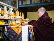 Tribute to Shamar Rinpoche: Thaye Dorje, His Holiness the 17th Gyalwa Karmapa, places Shamar Rinpoche's relics on the main altar. Photo / Tokpa Korlo